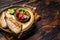 Roasted Gilthead Sea Bream fillets served with fresh vegetable salad. Wooden background. Top view. Copy space