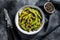 Roasted green edamame soybeans, japanese food. Black background. Top view