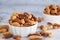 Roasted mixed nuts in white ceramic bowl