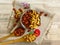 Roasted Natural Almond Nuts Badam and Cashew in a porcelain bowl. Two wooden spoons and Nuts spilled on handmade embroidered cloth