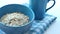 roasted oats flakes in a blue color bowl on table