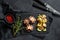 Roasted octopus. Baked potatoes  and celery. Black background. Top view