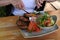 Roasted patties with salad served in restaurant