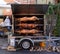 Roasted pigs on a spit, preparing food for guests of the folk festival