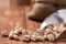 Roasted pistachios in metal scoop on wood table,wood background