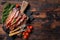 Roasted pork Bacon sizzling slices on wooden board. Wooden background. Top view. Copy space