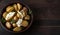 Roasted Potatoes in Wooden Bowl on Rustic Background, Copy Space