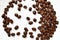 Roasted quality coffee beans spilled on white plate, roasted, brown