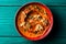 Roasted red bell pepper spread - muhammara - in a red bowl