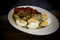 Roasted red peppers, sweet onions, aubergines and boiled eggs on wooden background