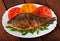 Roasted river fish carp on a white plate