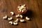 Roasted salted raw cashew nuts in wooden bowl on rustic table, healthy vegetarian snack, Anacardium occidentale, Cashews on white