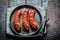 Roasted sausage with fresh herbs on hot barbecue dish