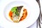 Roasted Sea Bass served on a white plate rich in healthy fatty acids from fish