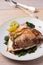 Roasted sea bream with spinach. Dorado or dorada fish fillet on white plate.