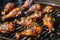 Roasted seasoned juicy chicken drumsticks over flame on a barbecue grill. AI Generated