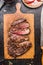 Roasted sliced grill steak on wooden cutting board