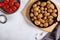 Roasted small whole potatoes in a cast iron skillet on concrete background. Top view, copy space, food background. Vegetarian or
