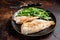 Roasted Snapper, sea red perch fillet on a plate with salad. Dark background. Top view