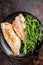 Roasted Snapper, sea red perch fillet on a plate with salad. Dark background. Top view