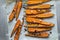 Roasted spring carrots on parchment with garlic, pepper peas and coriander