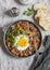 Roasted sweet potato, quinoa and fried egg bowl. Delicious healthy breakfast or lunch.