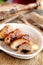 Roasted Turkey breast rolls stuffed with cheese and agaricus. Festive food recipe. Rustic style. Vertical photo