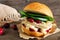 Roasted turkey sandwich with cranberry sauce and cheese against wood