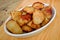 Roasties in a serving dish