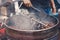 Roasting chestnuts with traditional machinery in a vendor in Chinatown, Malaysia