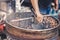 Roasting chestnuts with traditional machinery in a vendor in Chinatown, Malaysia