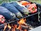Roasting eggplants and red peppers over a campfire