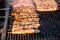 Roasting souvlaki meat sticks on hot outdoor charcoal fire grill. Pork, chicken Greek street food grilled meat.