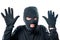 Robber in black protective clothing with hands up close-up