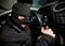 Robber and the thief in a mask hijacks the car