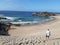 Robberg Beach, man walking down dune towards ocean