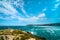 Robberg Peninsula, Robberg nature reserve landscape seabird flying up on sky. South Africa, Garden route.