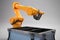 robot arm picks up toolbox and places it into robotic hand