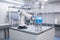 robot, cleaning and sanitizing benchtop in cleanroom, with equipment for scientific research visible