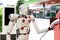 Robot cyber future futuristic humanoid Hi tech industry garage EV-car charger recharge refuel electric station vehicle transport