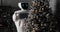 Robot decorates the Christmas tree. Cybernetic system today. Modern Robotic Technologies. Humanoid autonomous robot.