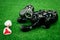 Robot dog Aibo of black color lies on a green artificial lawn