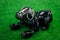 Robot dog Aibo of black color lies on a green artificial lawn