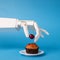 Robot hand decorating sweet cupcake with fresh cherry
