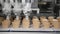 Robot machine Automatically pours ice cream in a Wafer cups. The conveyor automatic lines for the production of ice