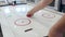 Robot plays with a man in table hockey. Media. High technologies of robots development