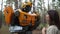 Robot transformer Bumblebee and girl stand together among forest