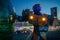 Robot transformer Bumblebee stands in street and glows in dark against night city