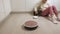 Robot vacuum cleaner collects trash in the kitchen. Modern technology