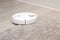 Robot vacuum cleaner drives on carpet. Overcoming obstacles with robot vacuum cleaner. ideal cleaning of house with modern